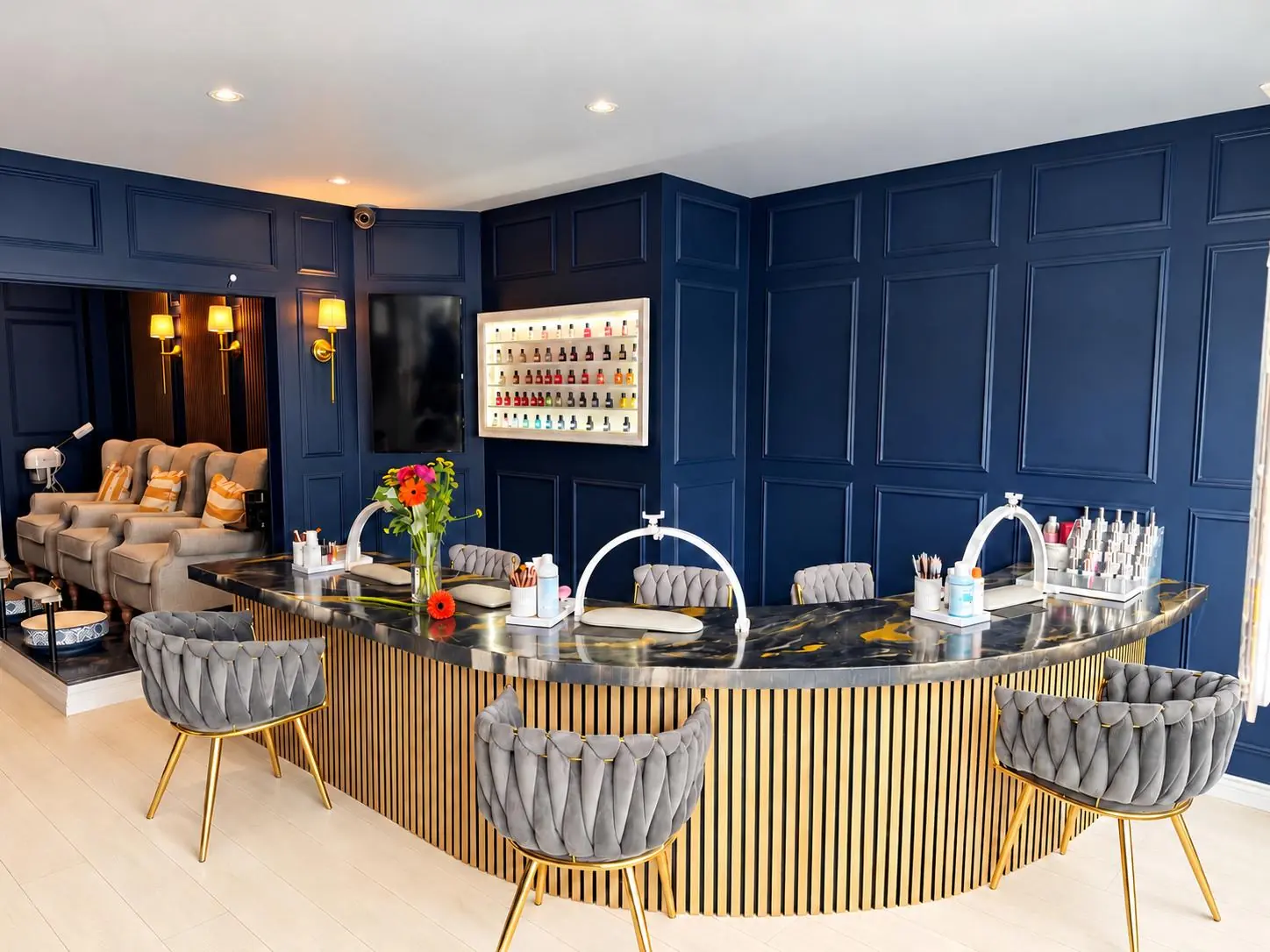 Inside the SHOW studio: navy panelled walls, a gold and marble counter and velvet chairs