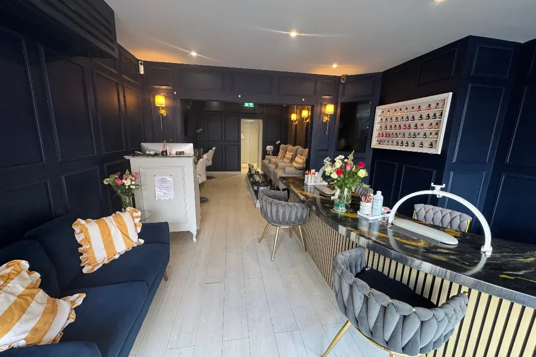 The SHOW lounge: a navy velvet sofa with gold striped cushions